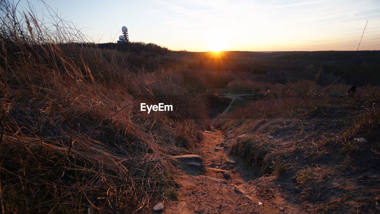 Scenic view of land against sky during sunset