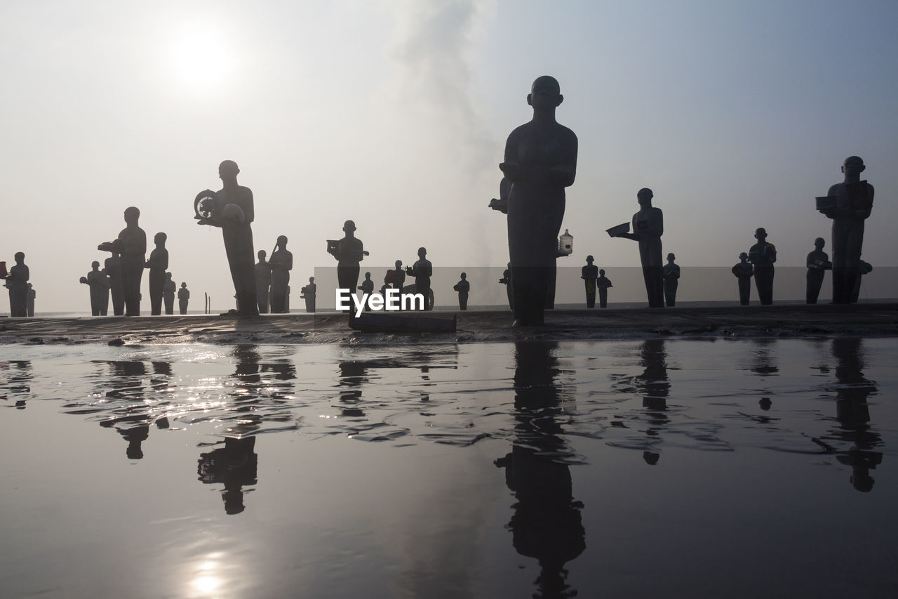 GROUP OF PEOPLE BY SWIMMING POOL