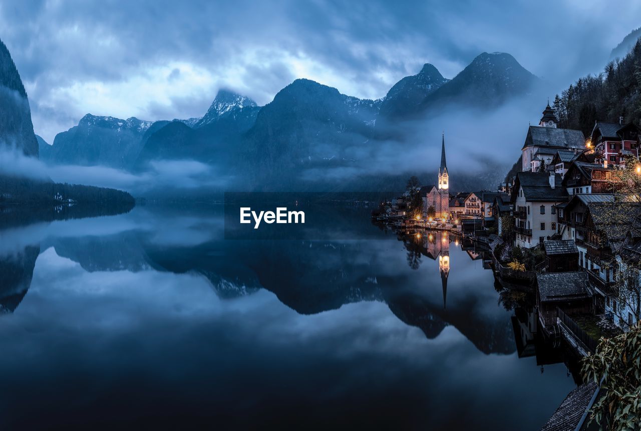 Scenic view of lake against sky at dusk