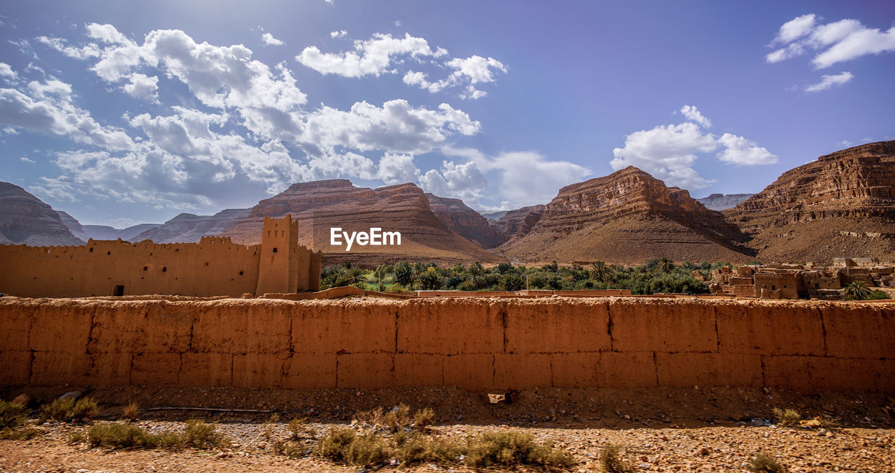 Panoramic view of land and mountains against sky