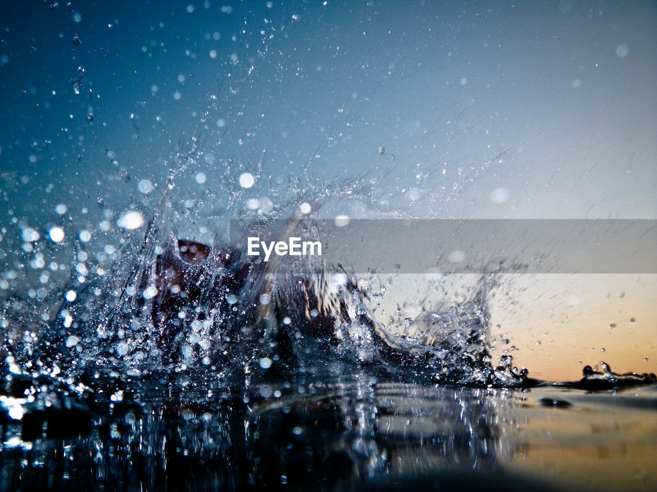 Water splashing in sea against sky