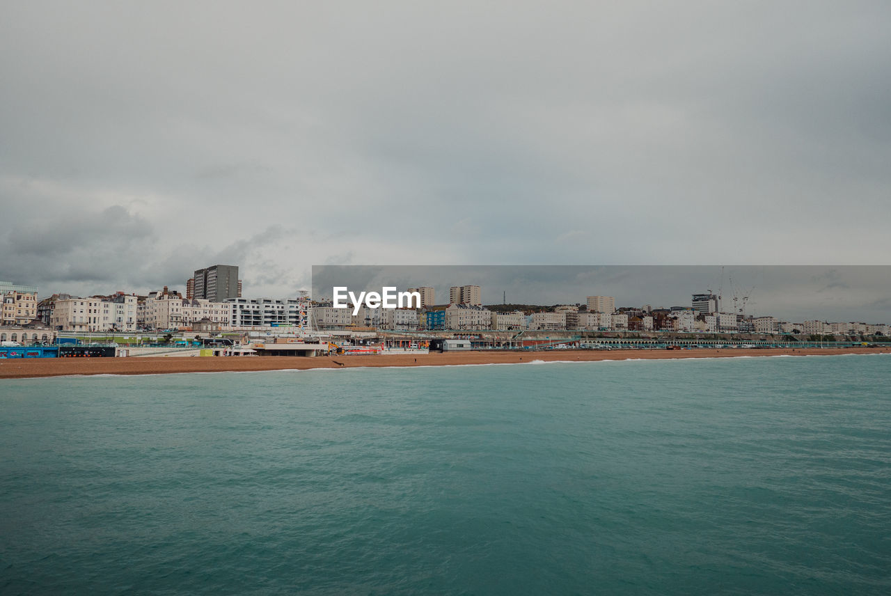 Scenic view of sea and buildings against sky