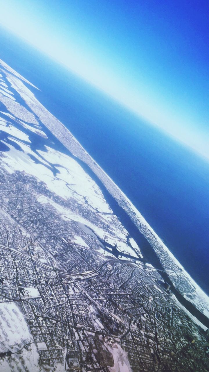 Aerial view of sea and cityscape