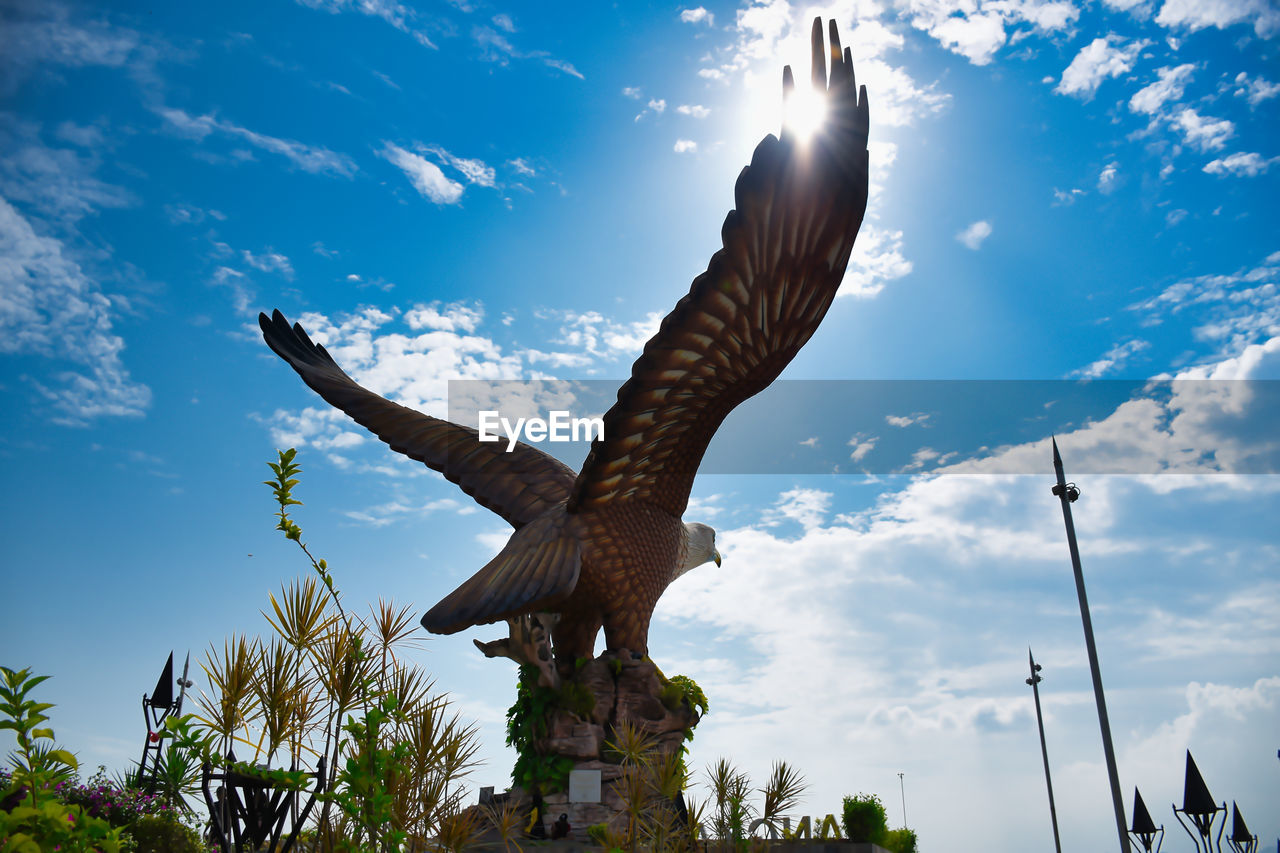 Eagle square or dataran lang a large sculpture of a reddish brown eagle to take flight