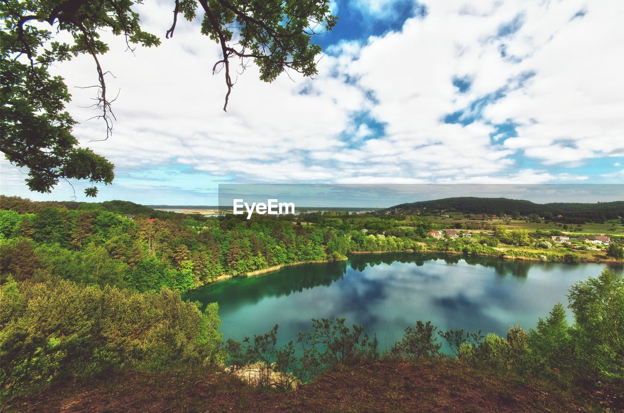 Scenic view of lake against cloudy sky