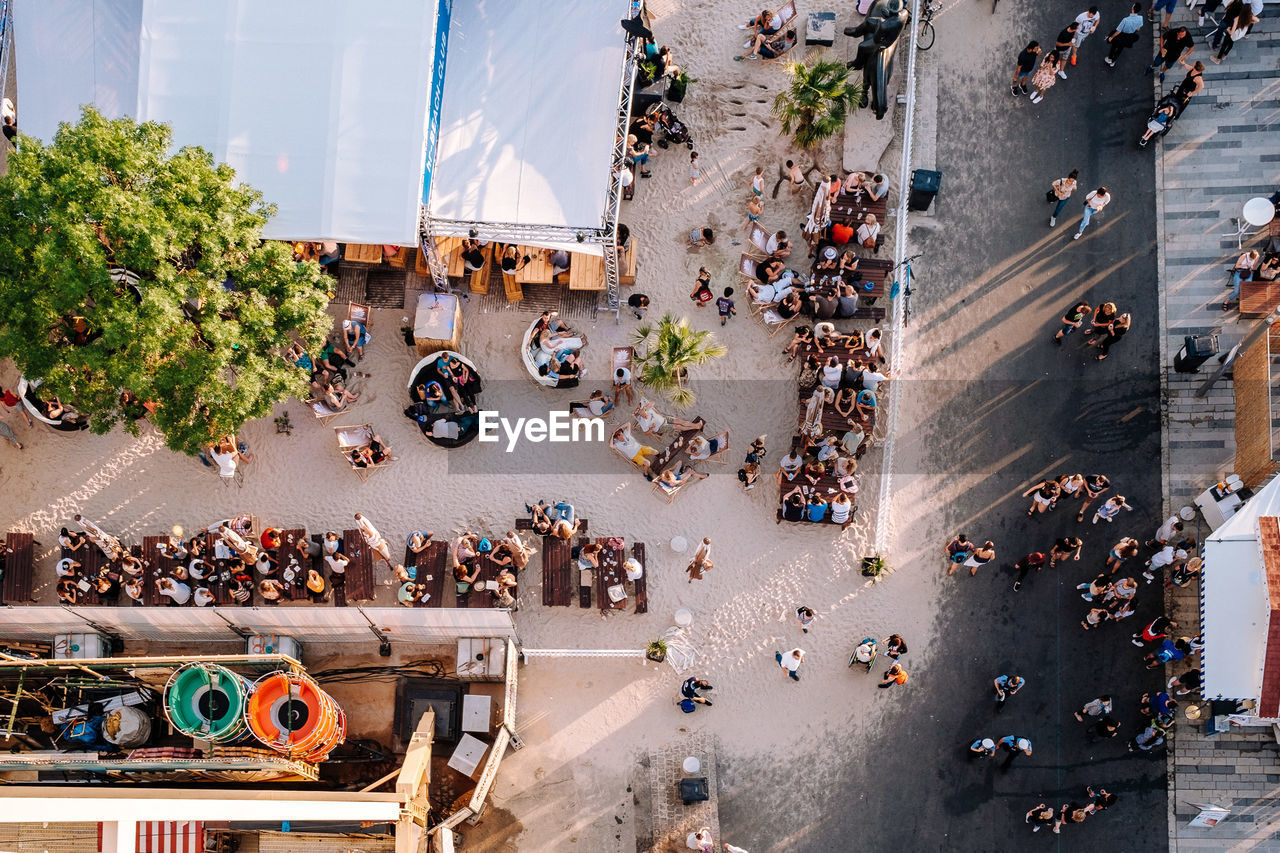 HIGH ANGLE VIEW OF CROWD ON STREET