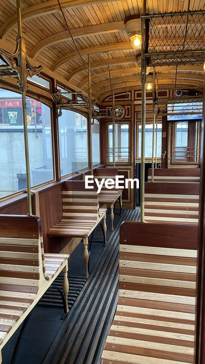 vehicle, indoors, seat, window, mode of transportation, transportation, architecture, no people, vehicle interior, travel, train, rail transportation, public transportation, vehicle seat, day, transport, interior design, absence, empty, yacht, wood, sunlight, built structure