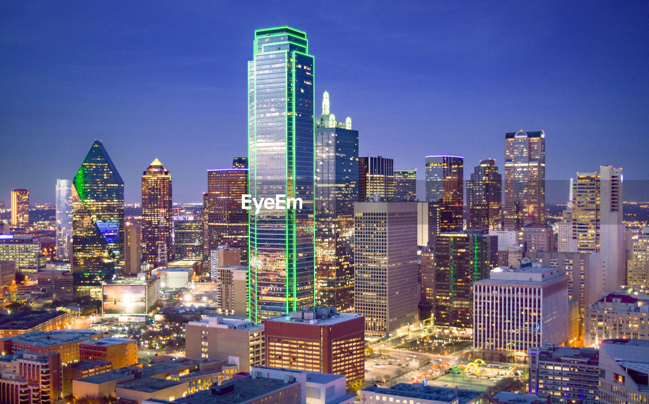 ILLUMINATED BUILDINGS AGAINST SKY IN CITY