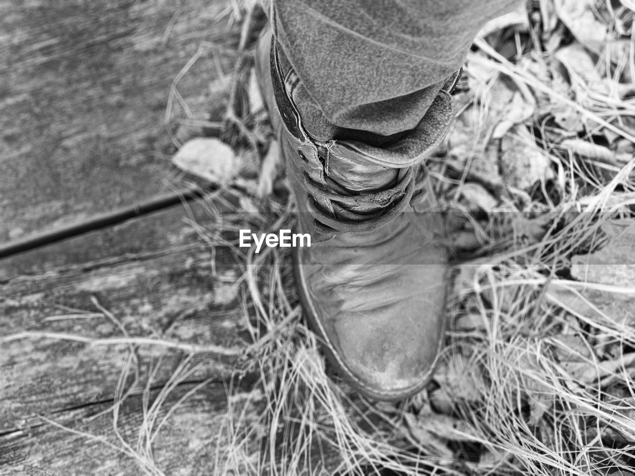 black and white, day, one person, low section, high angle view, human leg, nature, monochrome photography, plant, land, monochrome, field, grass, outdoors, shoe, close-up, footwear, lifestyles, standing, focus on foreground, men, dry