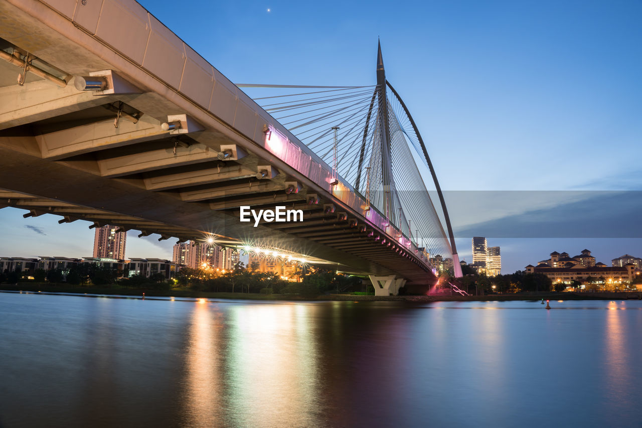 ILLUMINATED BRIDGE OVER RIVER