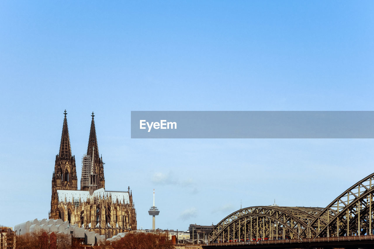 Cologne cathedral and hohenzollern bridge against clear sky in city