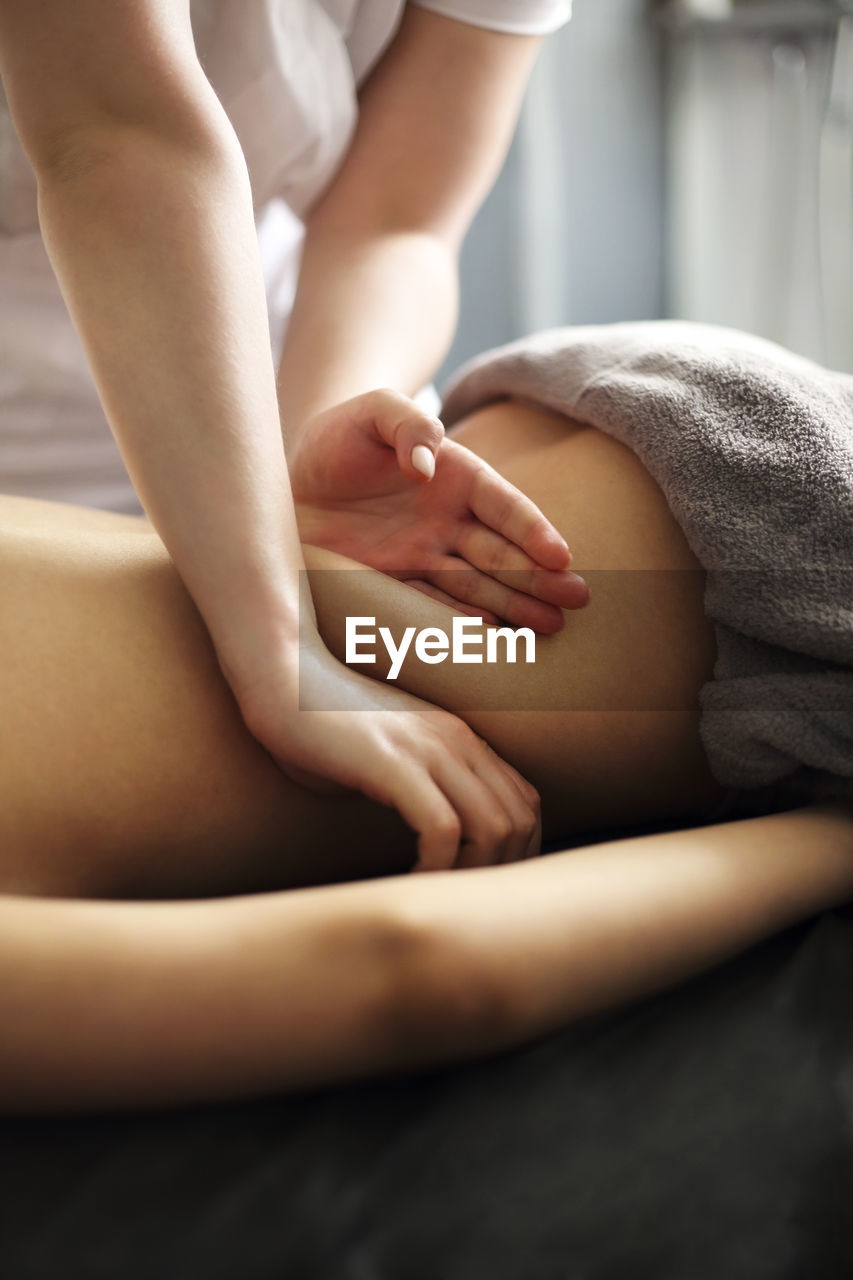 Therapist massaging woman at spa