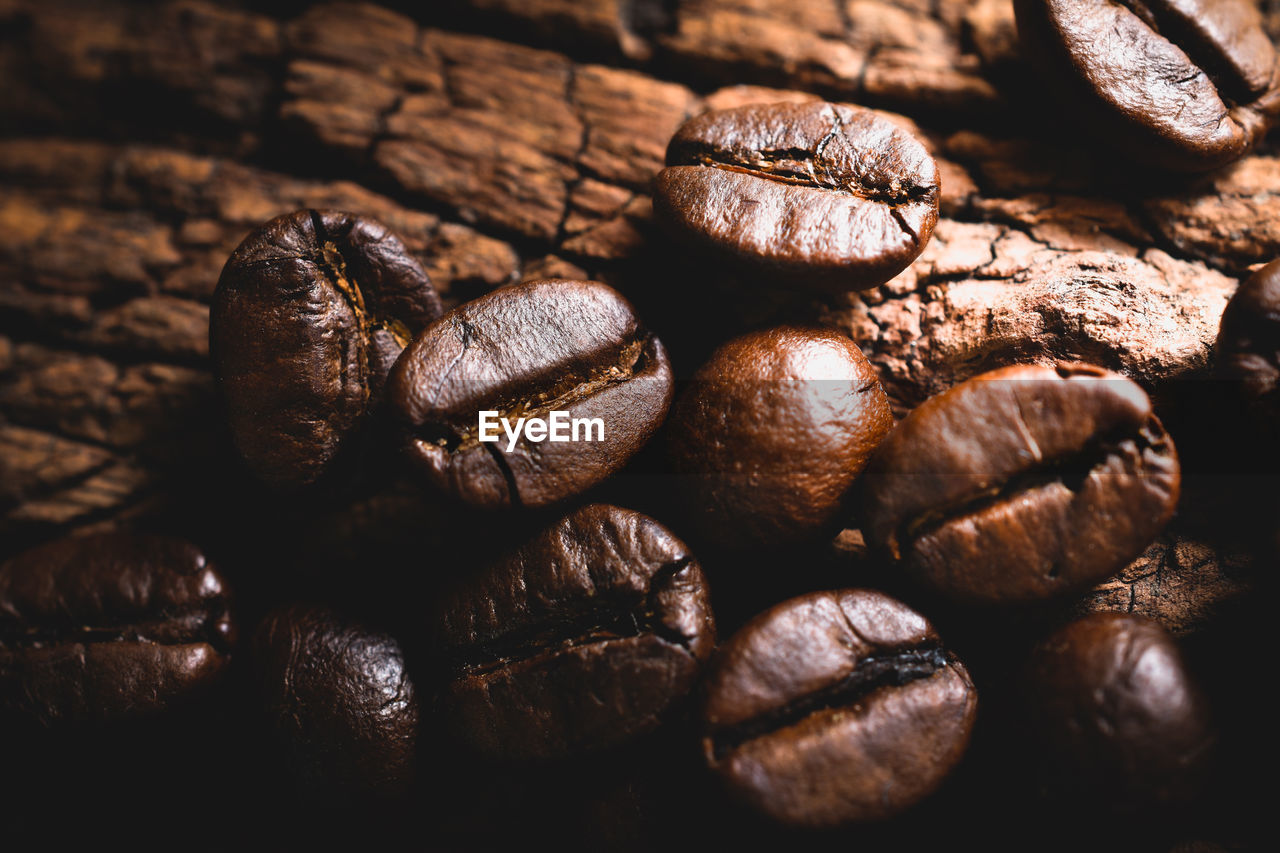 High angle view of roasted coffee beans on wood