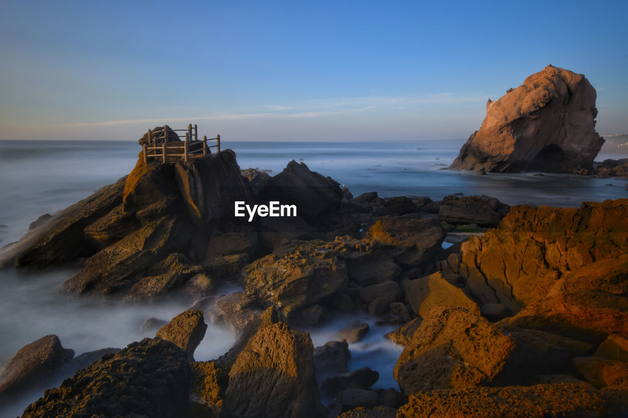 Scenic view of sea against sky at sunset