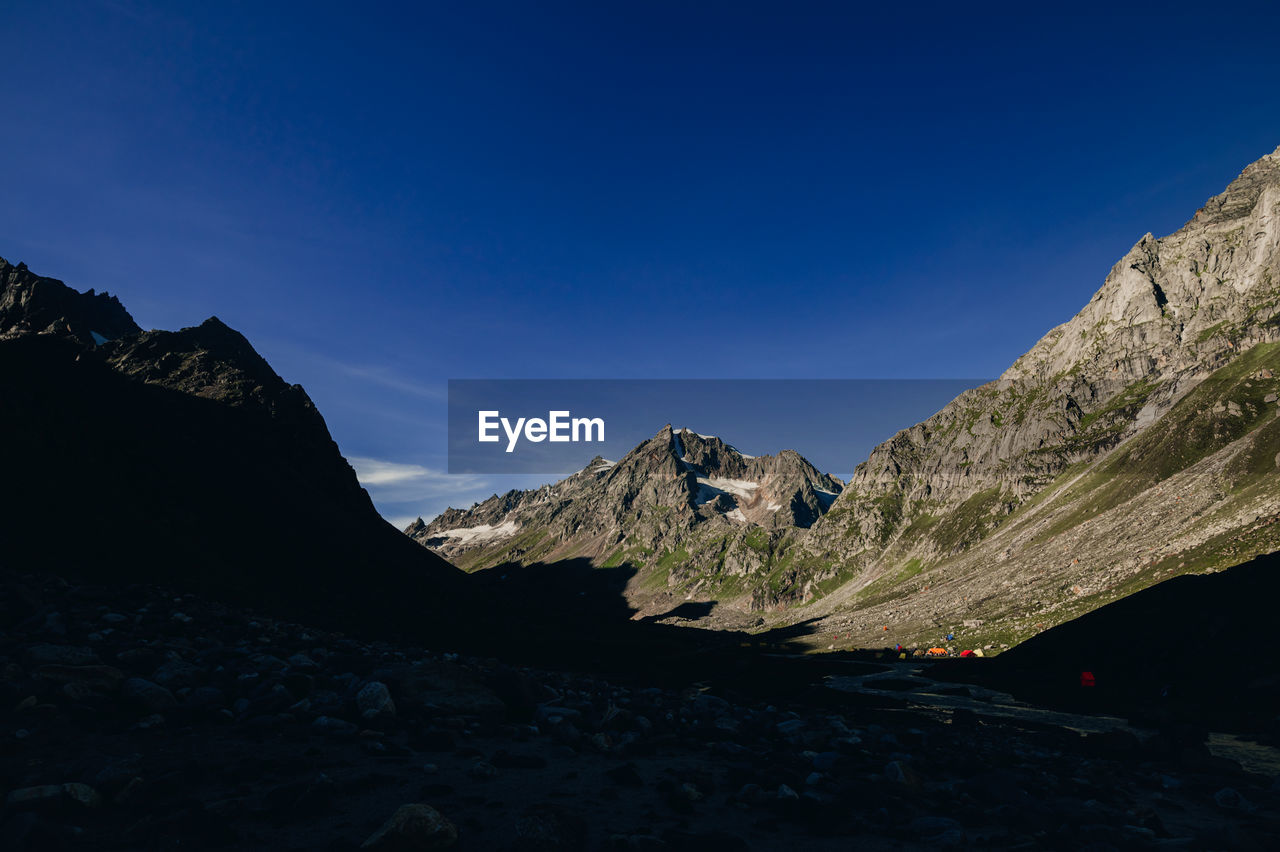 mountain, sky, scenics - nature, environment, mountain range, landscape, beauty in nature, nature, travel, travel destinations, land, rock, blue, mountain peak, no people, clear sky, adventure, wilderness, snow, outdoors, cold temperature, activity, tranquility, leisure activity, non-urban scene, ridge, tranquil scene, terrain, summit, cloud, tourism, winter, valley, mountain pass, day