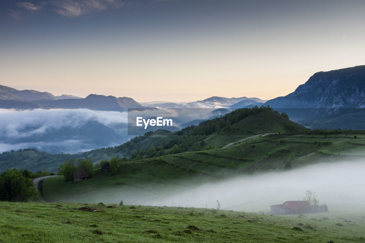 Scenic view of landscape and mountains against sky