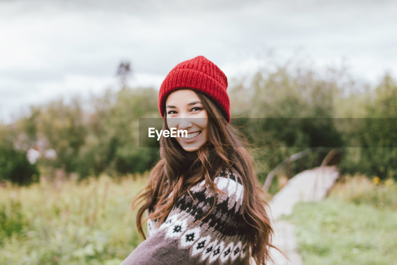 Portrait of smiling young woman in sweater