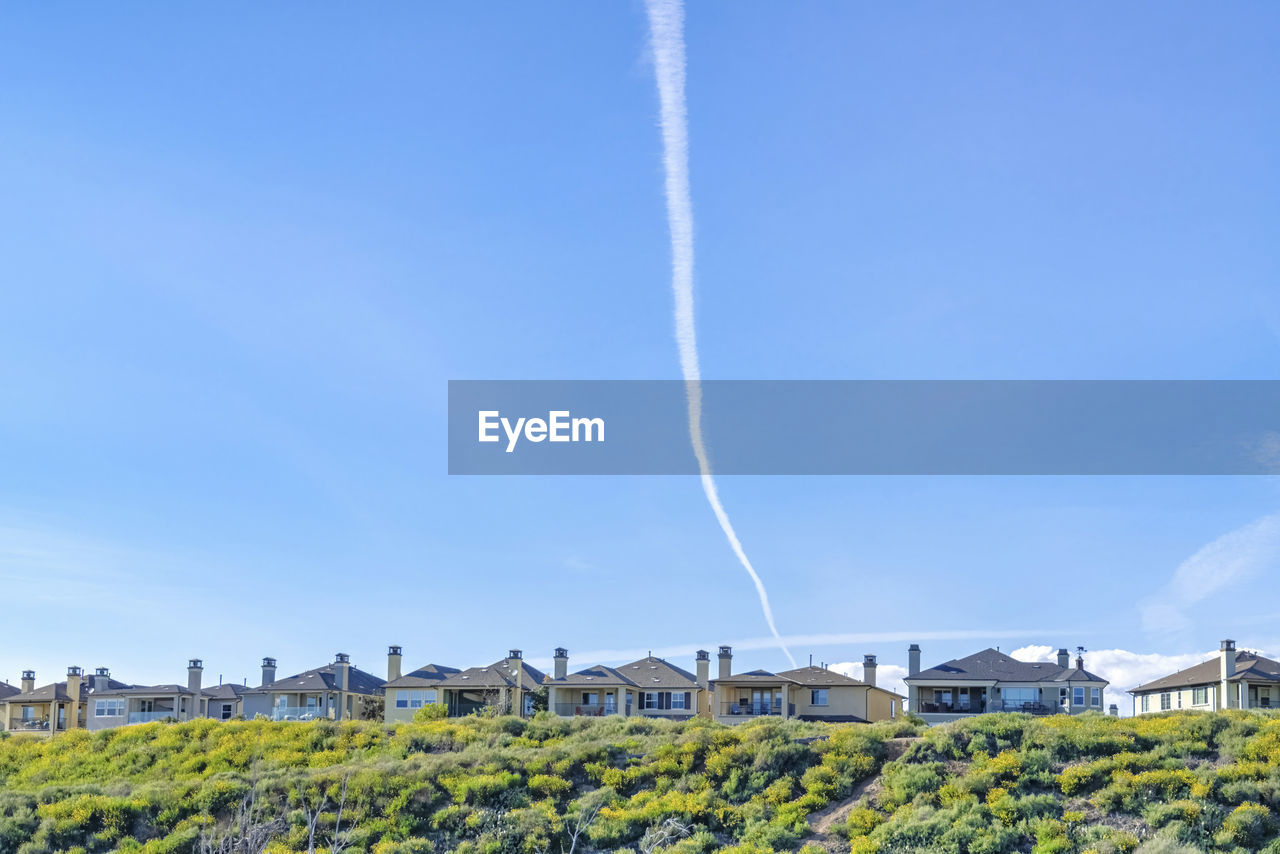 LOW ANGLE VIEW OF VAPOR TRAIL IN SKY