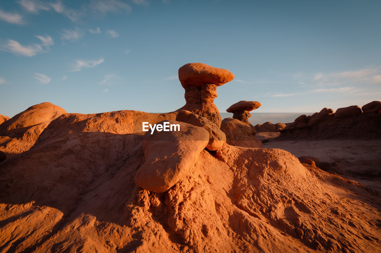 Hoodoos in goblin valley state park in utah at sunset.