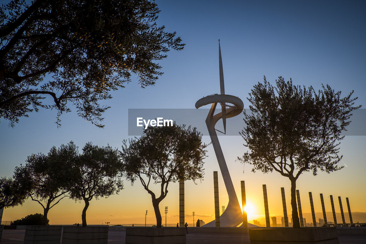 Low angle view of silhouette trees against sky during sunset