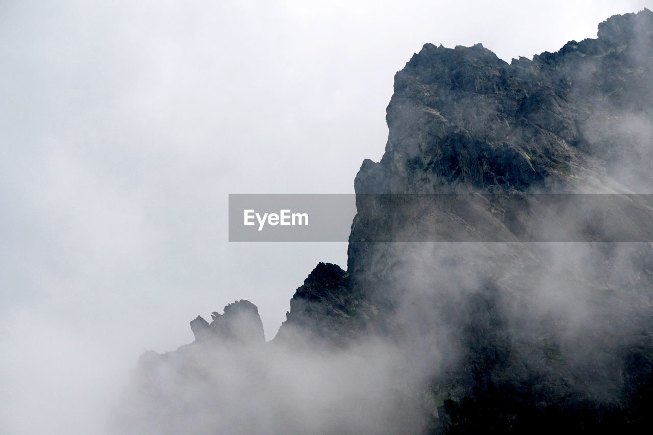 View of rock mountains amidst smoke