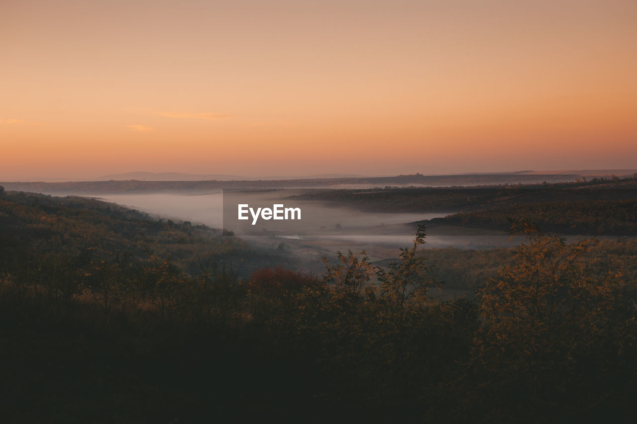 Scenic view of landscape against sky during sunset