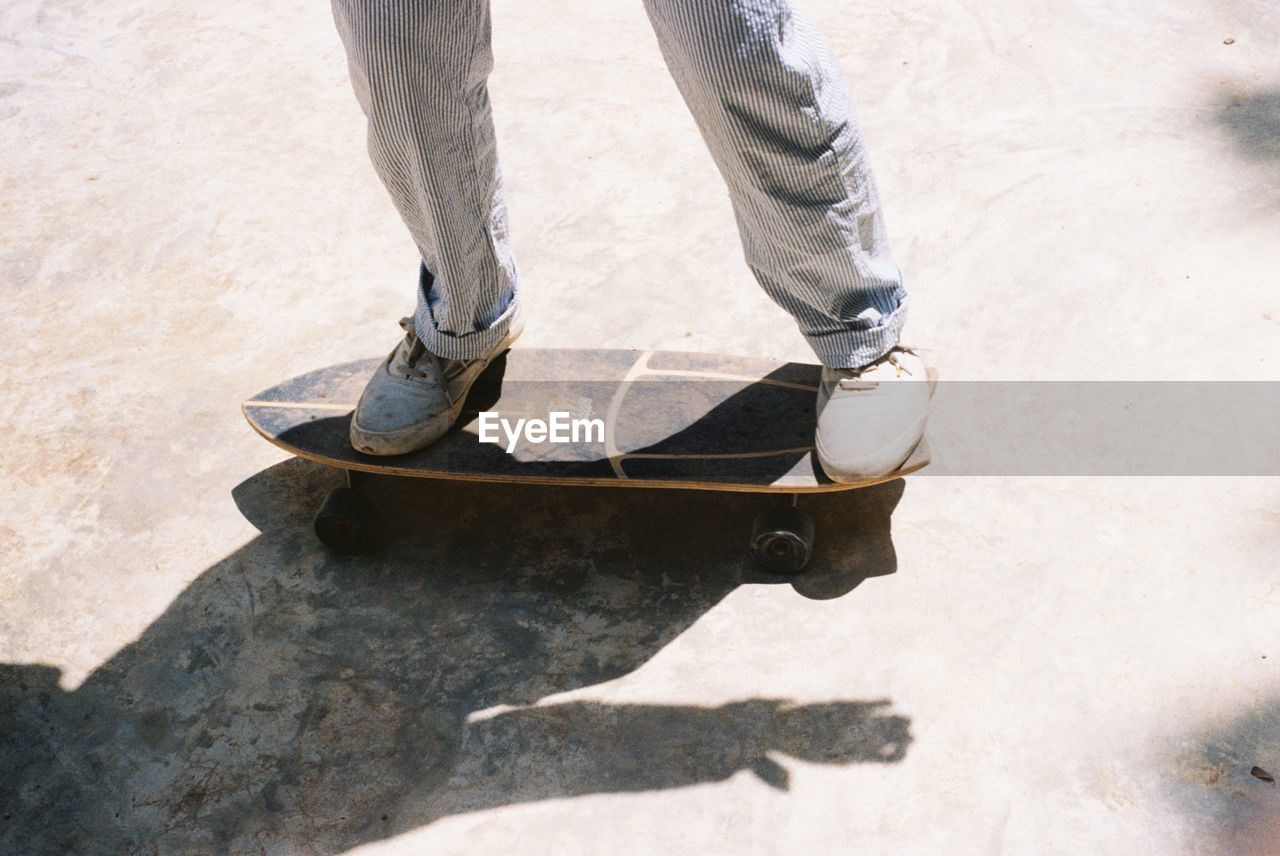 Low section of man standing on skateboard