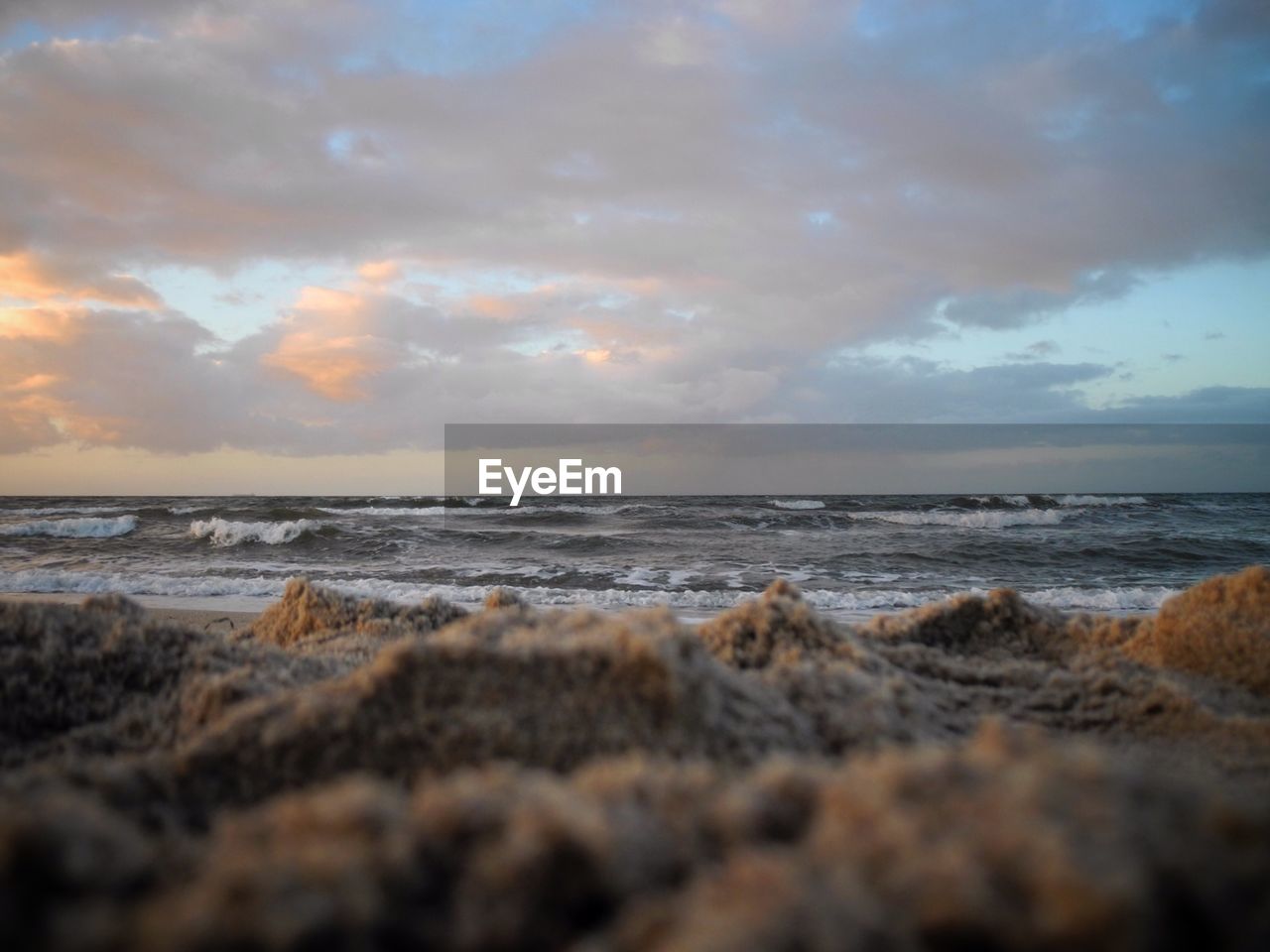 Scenic view of beach against sky during sunset