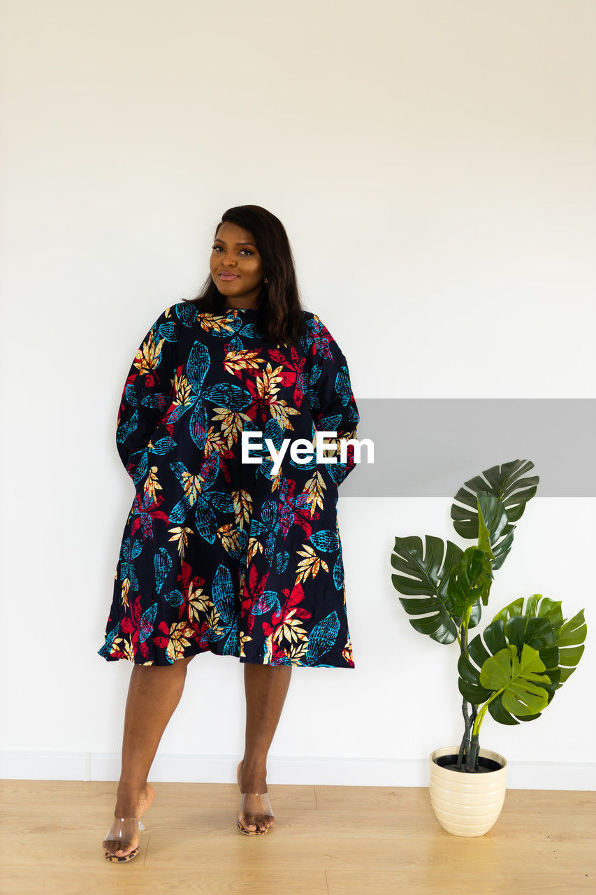 one person, full length, women, indoors, adult, spring, dress, standing, fashion, clothing, portrait, pattern, flower, studio shot, smiling, young adult, female, plant, art, lifestyles, nature, front view, looking at camera, happiness, emotion, photo shoot, hairstyle, casual clothing