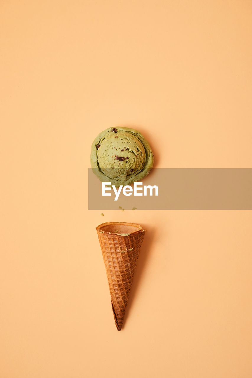 CLOSE-UP OF ICE CREAM AGAINST GRAY BACKGROUND