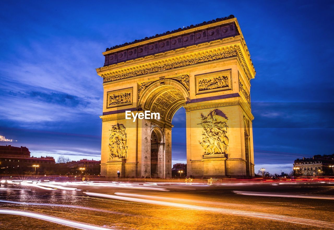 View of light trails by arc de triomphe