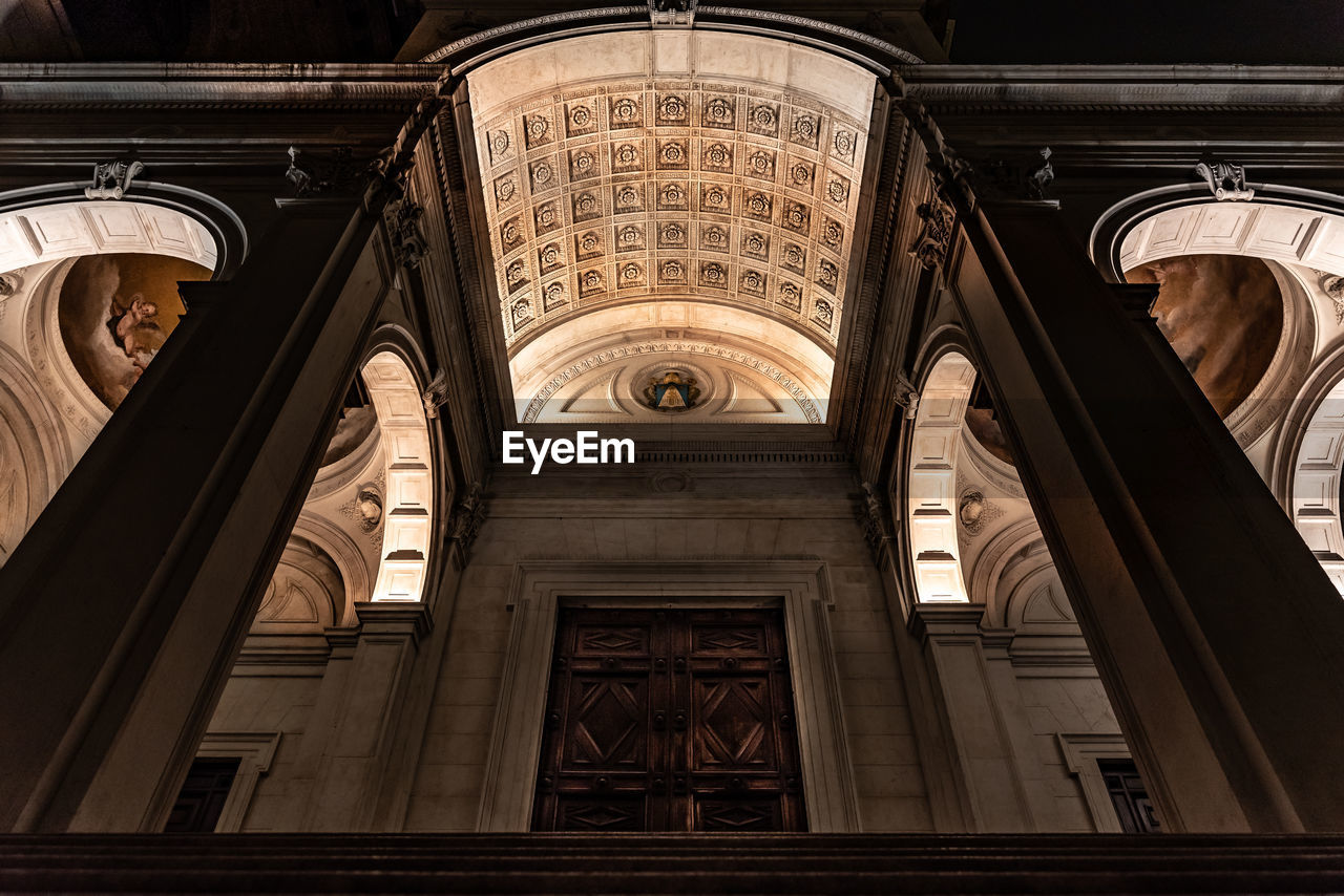 View from below of the entrance of the cathedral of sant'alessandro in bergamo illuminated at night