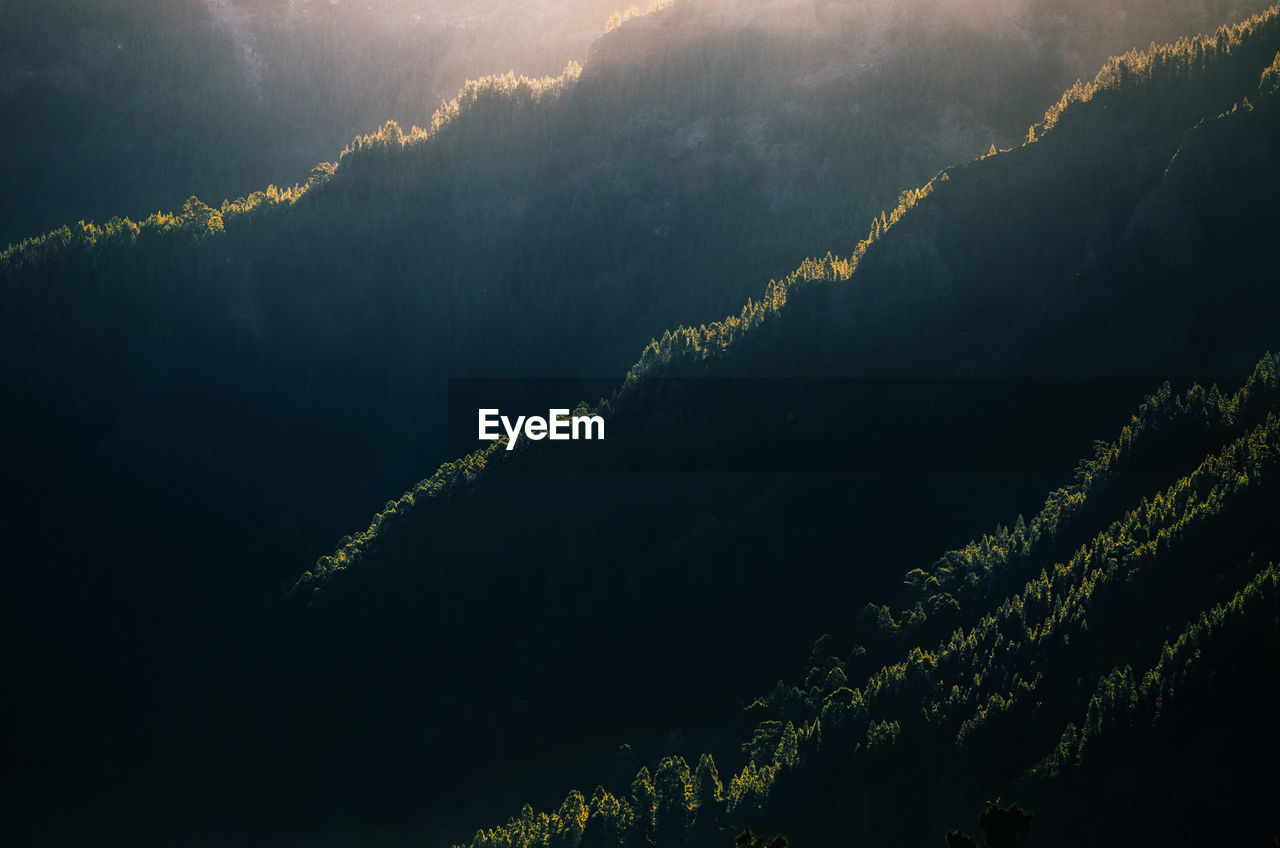 Scenic view of mountains against sky at night