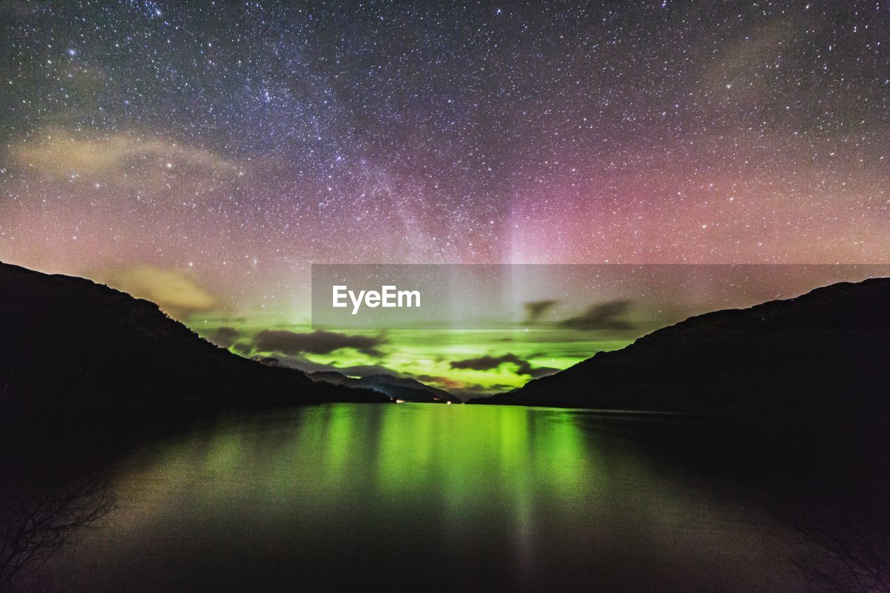 Scenic view of lake against sky at night