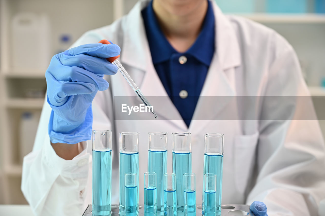 midsection of scientist working at laboratory