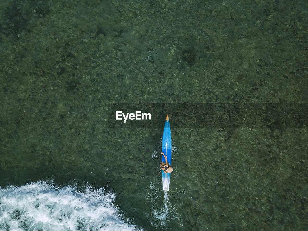 Young woman on stand up paddling board