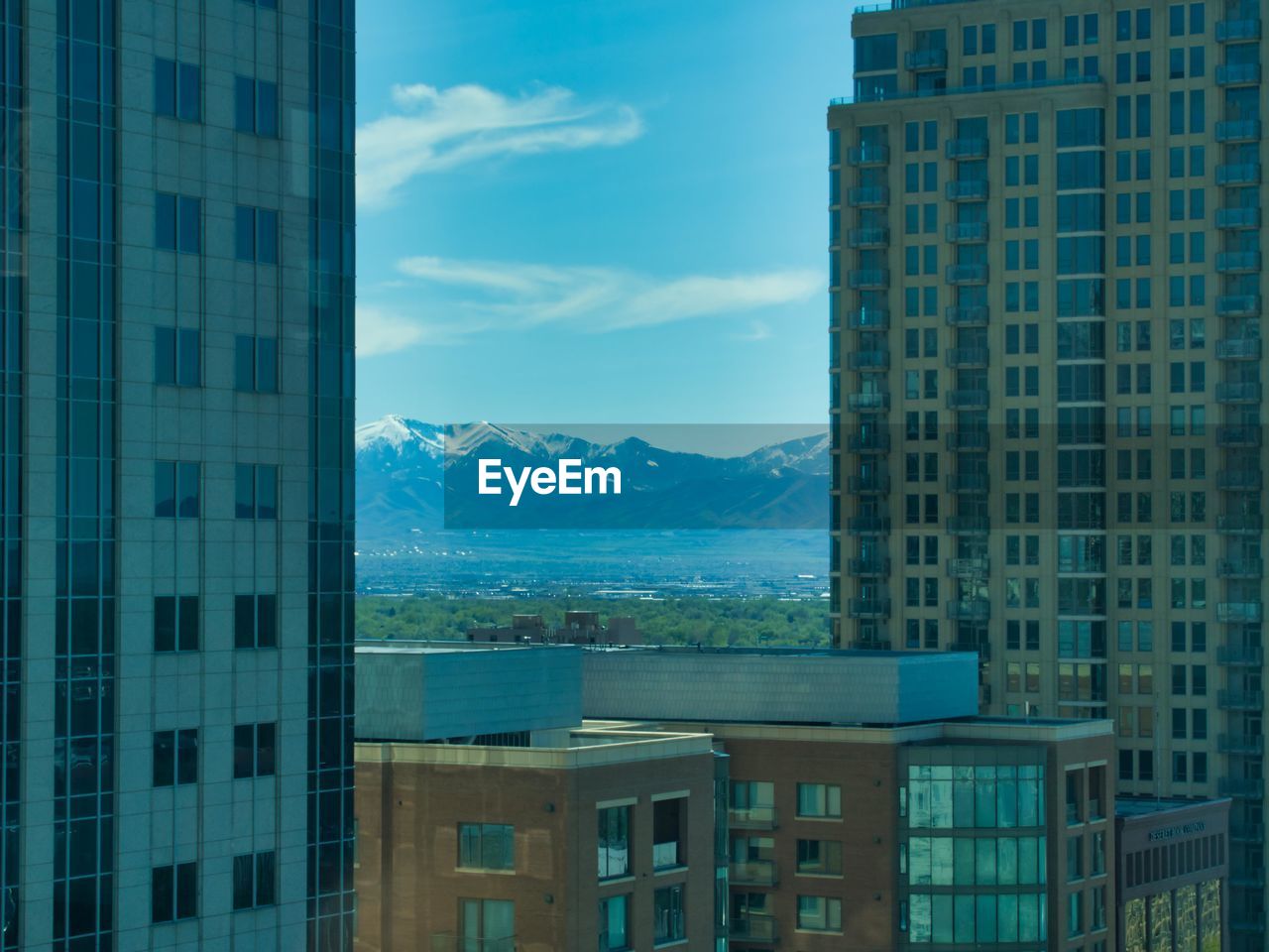 Buildings in city against blue sky