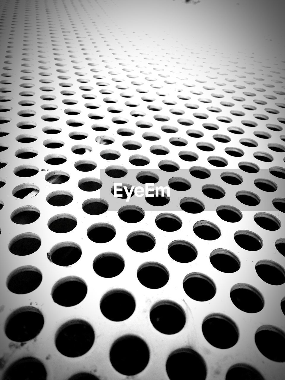Close-up of perforated metal bench