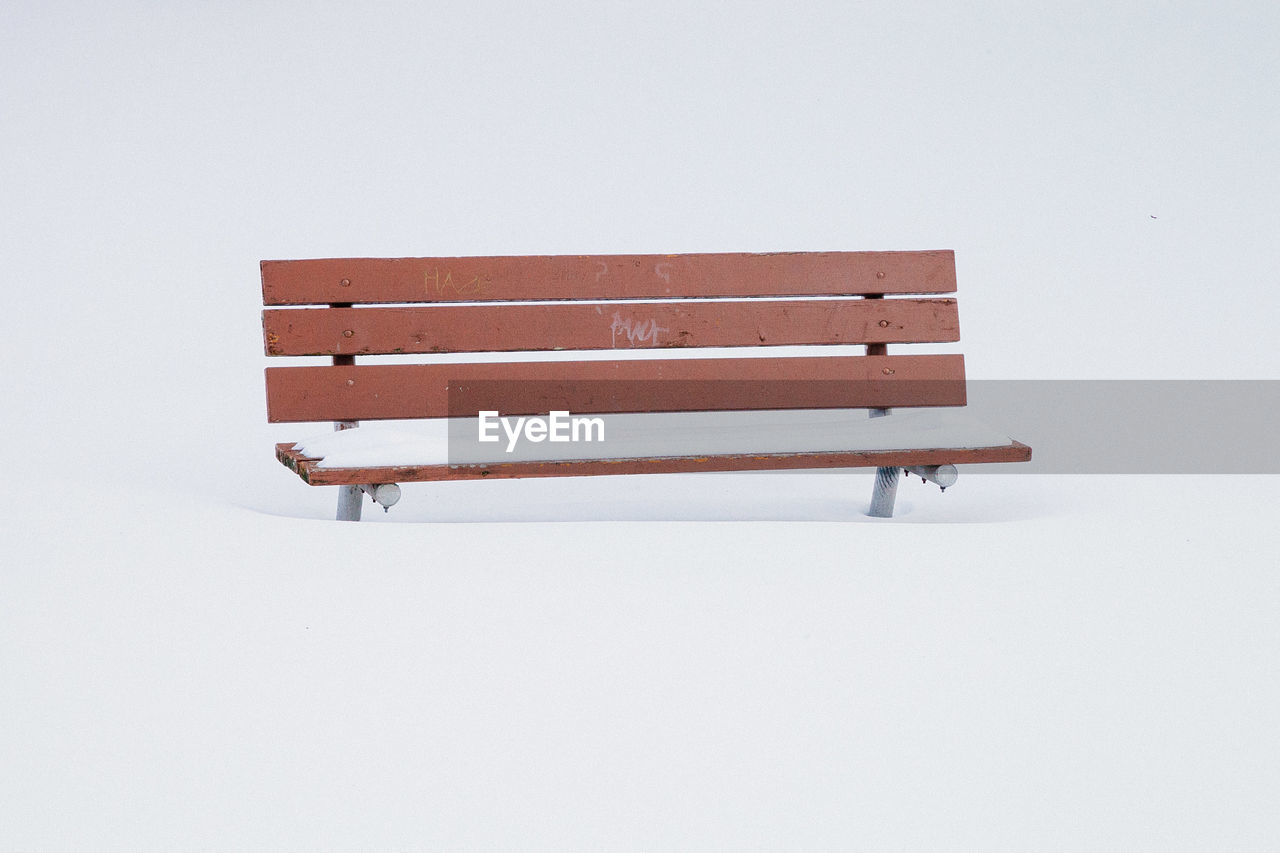 Empty bench on snow