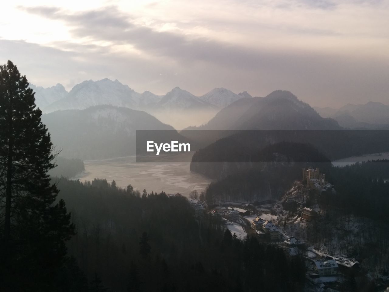 Scenic view of river and mountains against sky