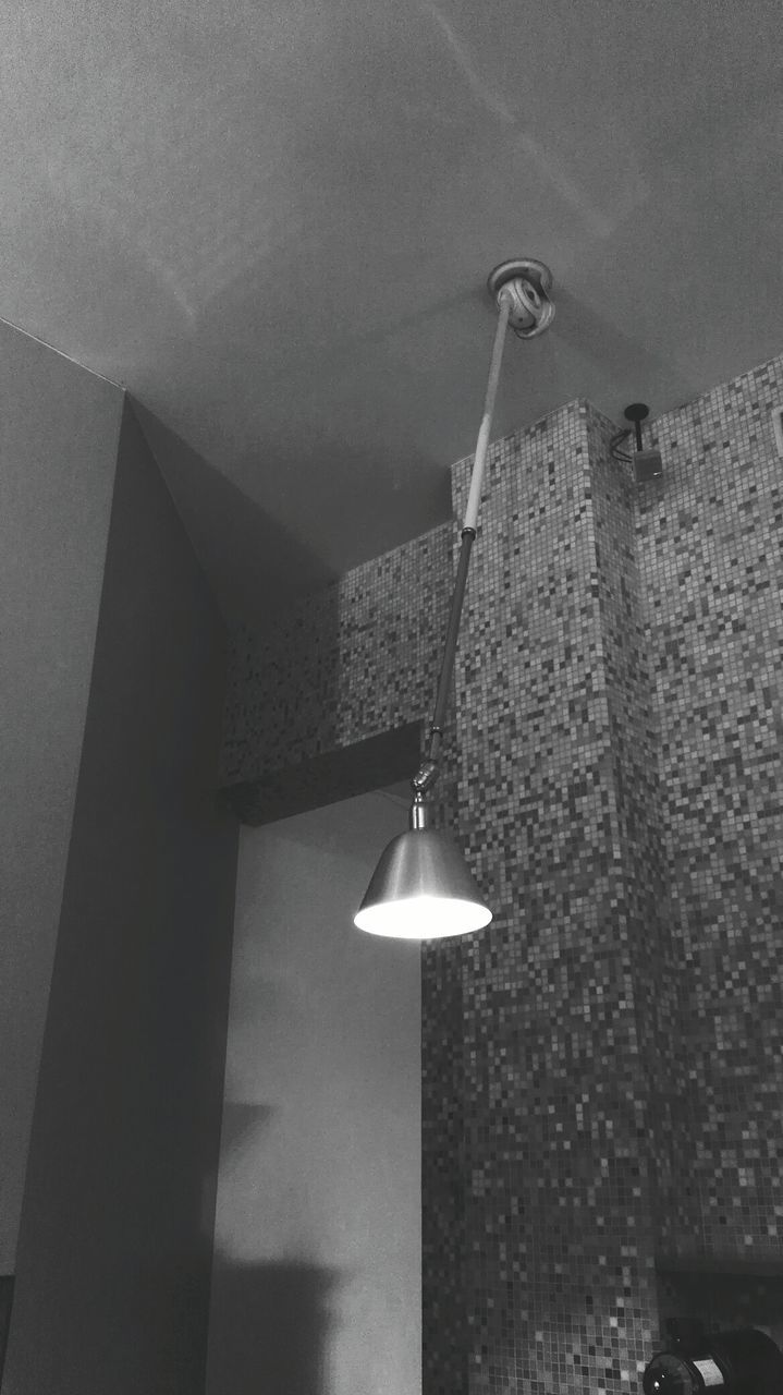 LOW ANGLE VIEW OF ILLUMINATED ELECTRIC LAMP HANGING ON WALL