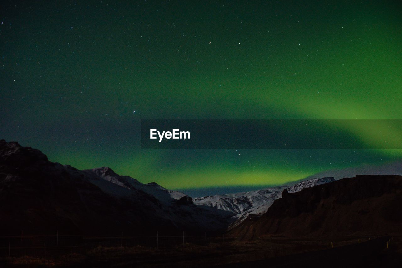 Scenic view of mountains against sky at night