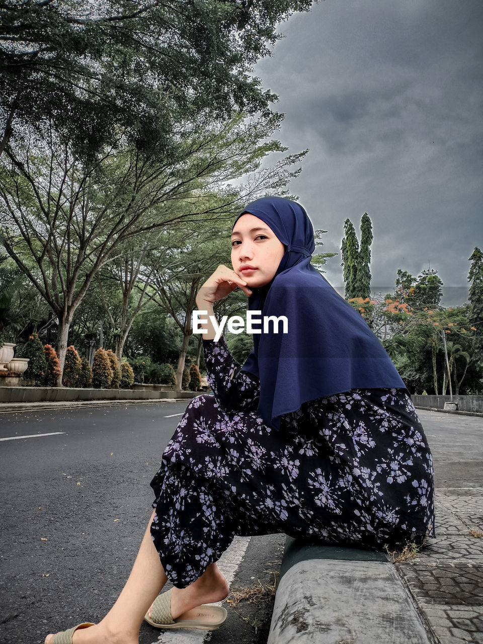 Portrait of young woman sitting outdoors