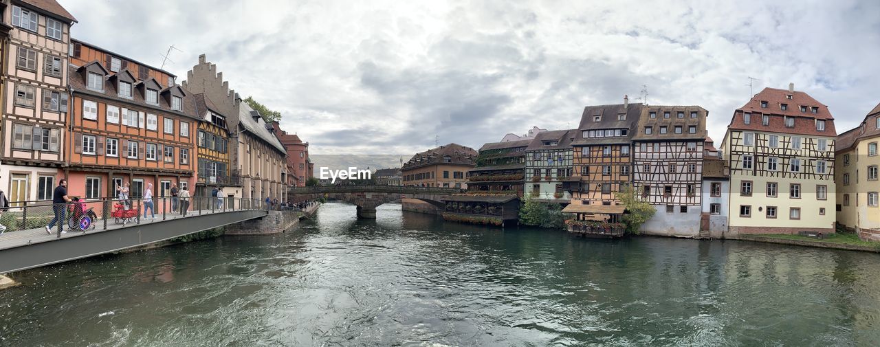 Canal passing through buildings in city