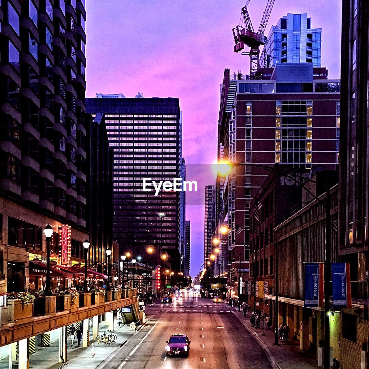 View of city street at sunset