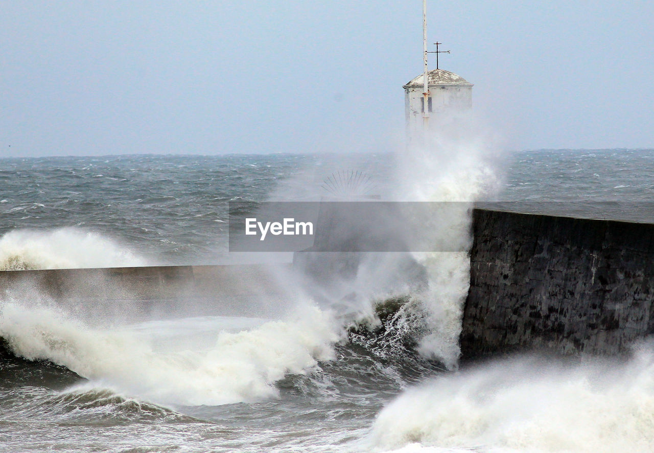 WAVES BREAKING AGAINST SEA