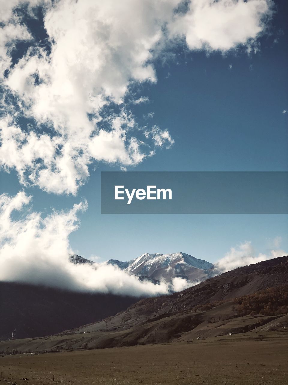 mountain, environment, landscape, sky, scenics - nature, cloud, beauty in nature, snow, nature, land, cold temperature, mountain range, winter, travel, horizon, snowcapped mountain, travel destinations, sunlight, no people, outdoors, non-urban scene, tourism, tranquility, tranquil scene, day, blue, cloudscape, plateau, awe, holiday, dramatic sky, mountain peak