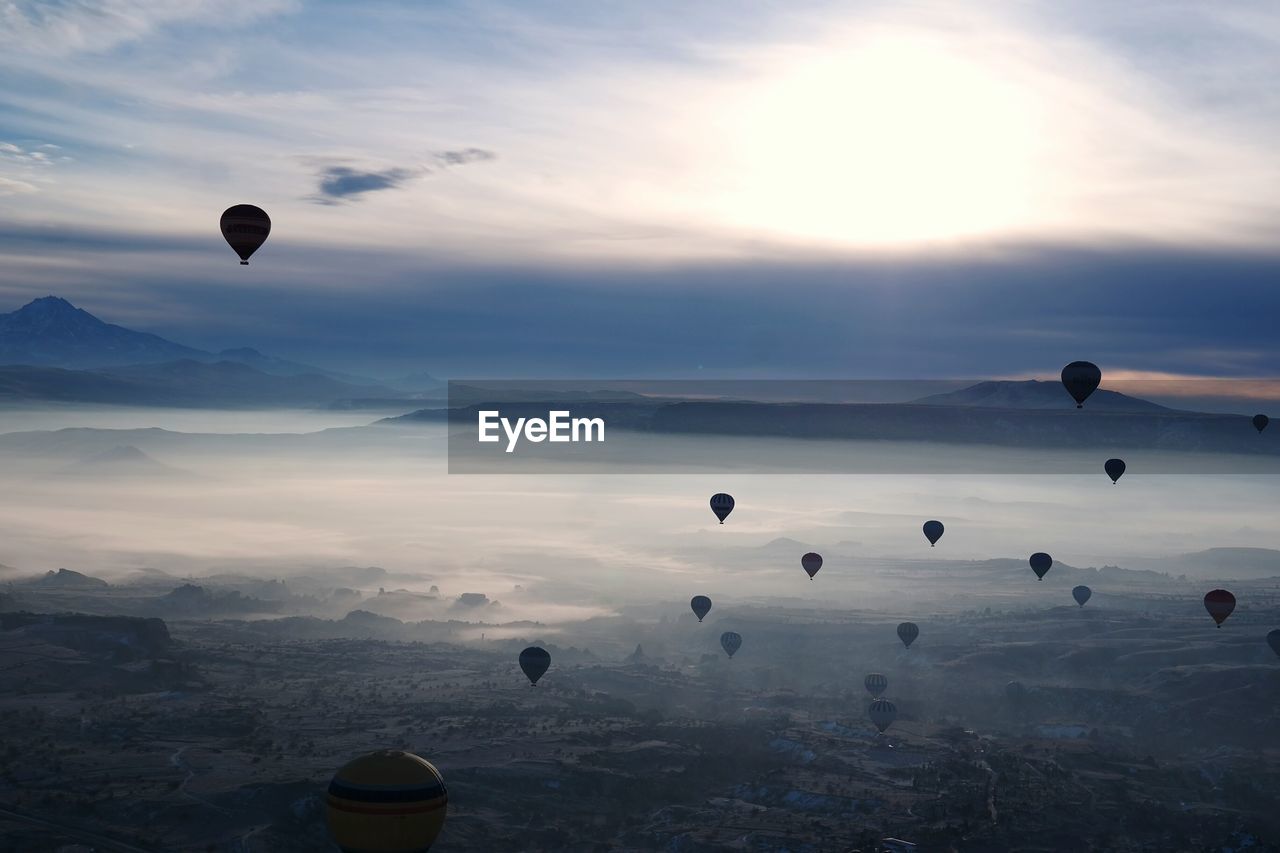 Hot air balloons flying at cappadocia during sunset