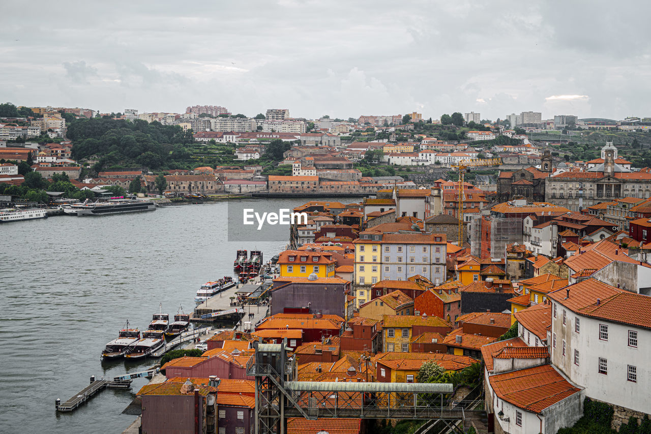 High angle view of river by buildings against sky