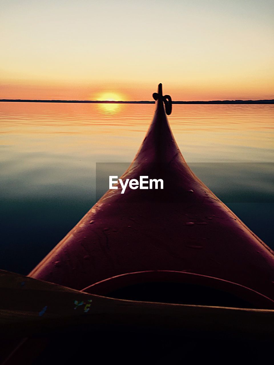 Close-up of water against sky during sunset
